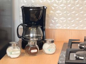 a black coffee maker sitting on a counter with two candles at Exclusivo Apartamento Céntrico con Terraza Privada in Sogamoso