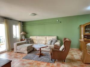 a living room with a couch and a table and chairs at Villa Cala Encantada Sea View Apartments with Pool in Calpe