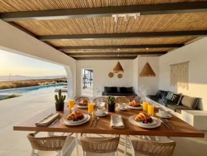 a dining room with a table with food on it at Faragas Hill Euphoria Villa in Angairiá