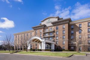 a large brick building with an arch in front of it at Holiday Inn Midland by IHG in Midland