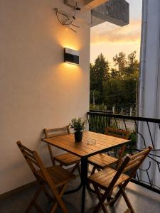 a wooden table and chairs on a balcony at Chill Kobuleti in Kobuleti