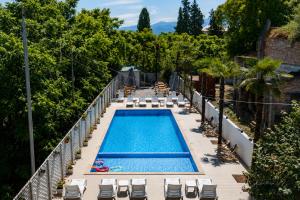a swimming pool on a balcony with chaises and chairs at Chill Kobuleti in Kobuleti