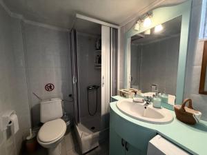 a bathroom with a toilet and a sink and a shower at Ellis house Agnanti in Kalives Poligirou +35 photos