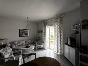 a living room with a couch and a table at Ellis house Agnanti in Kalives Poligirou