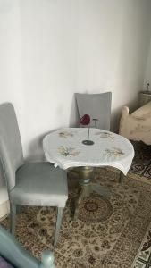 a table and a chair with a table and a table at Beit Emna2 in Kairouan