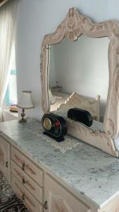 a dresser with a mirror on top of it at Beit Emna2 in Kairouan