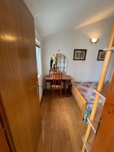 a room with a desk and a table with a chair at Stas Apartments in Đenovići +9 photos