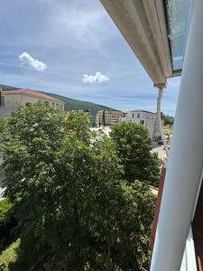 a view of a tree from a balcony at Stas Apartments in Đenovići