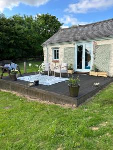 a deck in front of a house with a patio at Hillhead Farm Bed and Breakfast in Cullompton