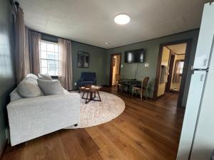 a living room with a couch and a table at Highland House and Cottages in Carroll