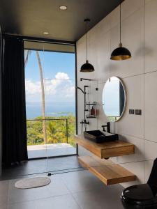 a bathroom with a sink and a mirror and a window at AGV II Cayo View in Monte Rojo