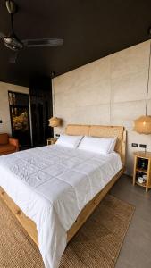 a bedroom with a large bed with white sheets at AGV II Cayo View in Monte Rojo