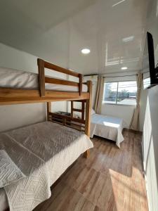 a bedroom with two bunk beds and a window at View Theras Hotel in Doradal