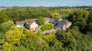 an aerial view of a large house in the forest at Domein Fonteinhof B&B in Borgloon