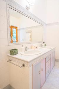 a bathroom with two sinks and a large mirror at Villa Lepre in Casarza Ligure +35 photos