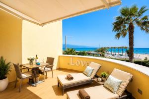 a patio with a table and chairs and a view of the beach at Villa Maria Luisa in Cagliari
