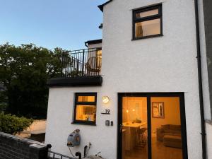 a white house with black windows and a balcony at Williamson House Lancaster in Lancaster +13 photos