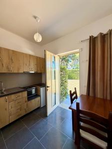 a kitchen with a table and a dining room at "Seaside Pines" Apartments in Vlorë +50 photos