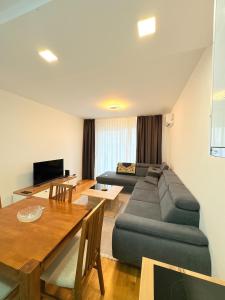 a living room with a couch and a table at Sky apartment in Sarajevo