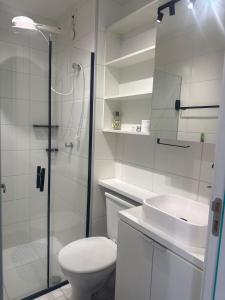 a bathroom with a shower and a toilet and a sink at Studio 44 Luxo Design Com Closet, Office e Ar in Mogi das Cruzes +19 photos