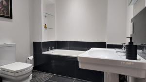 a white bathroom with a sink and a toilet at The Coach House in Alyth +51 photos