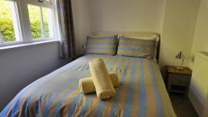 a bedroom with a bed with a towel on it at The Coach House in Alyth