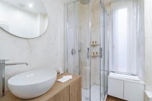 a bathroom with a large white sink and a shower at Ponte Milvio Roma Elegance Room & Private Parking in Rome +46 photos