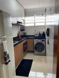a kitchen with a stove and a dishwasher at Apartamento SN Orlando Dantas in Aracaju