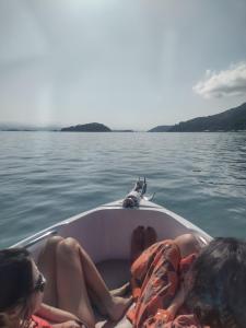 a group of people on a boat on the water at Lancha melodia paraty in Paraty