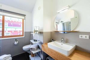 a bathroom with a sink and a mirror at hus9 in Mittelberg