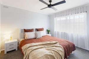 a bedroom with a bed and a ceiling fan at Kidston Arches - HotTub - 2 Min Walk to Golf Course in Mansfield