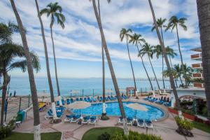 a view from the balcony of a resort with palm trees and a pool at Hotel Rosita in Puerto Vallarta