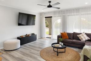a living room with a couch and a table at Kidston Arches - HotTub - 2 Min Walk to Golf Course in Mansfield