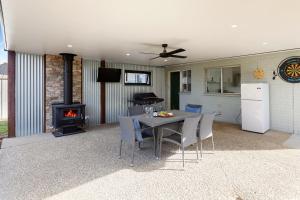 a patio with a table with chairs and a stove at Kidston Arches - HotTub - 2 Min Walk to Golf Course in Mansfield +9 photos