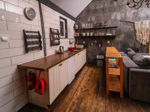 a kitchen with a counter and a couch in a room at Leśna Chata in Bierzów +43 photos