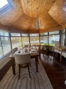 a dining room with a table and chairs and a chandelier at Robin Hill Bed and Breakfast in Curracloe
