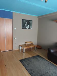 a living room with a couch and a blue ceiling at 2 precu 17 in Daugavpils