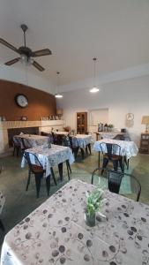 a dining room with tables and a ceiling fan at Hostería Amancay in Merlo