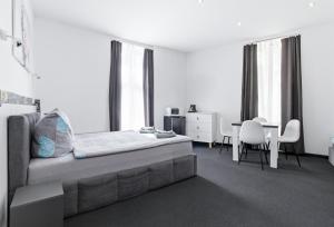 a bedroom with a bed and a table and chairs at 70s Guest room in Krakow