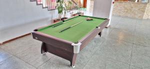 a pool table with cuesticks on top of it at Dom Turysty Sanok in Sanok