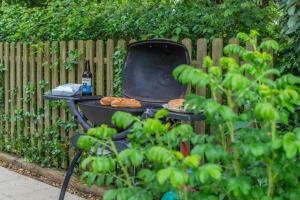 a grill with two pizzas and a bottle of wine at 1 Bed in Bude oc-s34881 in Bude +19 photos