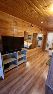 a living room with a large flat screen tv at Дом у моря in Suurupi