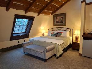 a bedroom with a bed and a chair and a window at Inn at Lake Joseph in Forestburgh +16 photos