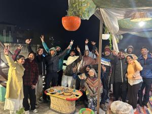 a group of people posing for a picture at night at Tiny Spot Hostel Rishikesh in Rishīkesh