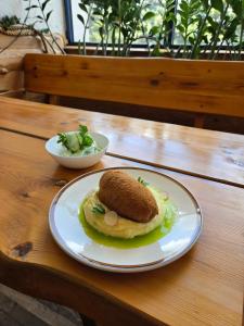 a plate with an omelet on a wooden table at Dom Turysty Sanok in Sanok