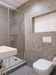 a bathroom with a toilet and a sink and a shower at Milada 7 Suits in Brno