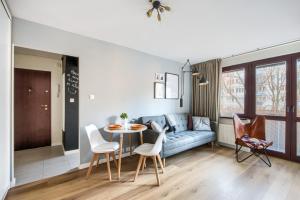 a living room with a couch and a table at Śliska Residence in Warsaw