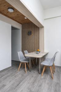 a dining room with a table and two chairs at Sole e Mare B1 Beachfront Sea View Apartment in Koutsourás