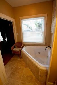 a bathroom with a large tub and a window at Shorelight Inn in Benicia +33 photos