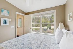 a bedroom with a bed and a large window at Selkie Village in Wells +18 photos